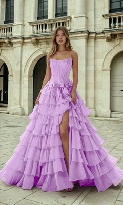 Woman wearing a lilac purple ruffled gown in front of an architectural building.