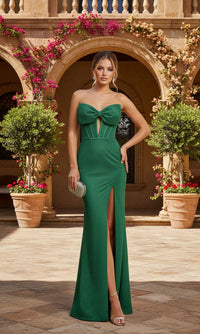 Woman in a green evening gown standing in front of an archway with floral decorations.