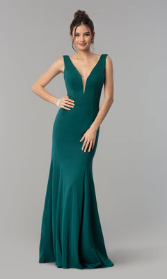 A woman models the Simple V-Neck Long Formal Jersey Prom Dress 8152 in green, featuring a sleeveless deep V-neck design, while standing against a plain gray background.