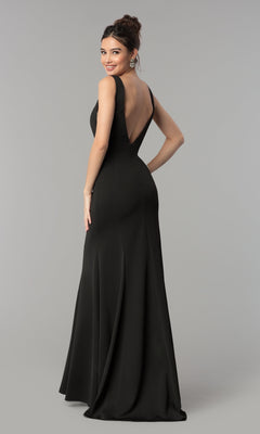 A woman smiles over her shoulder in the Sleeveless V-Neck Long Formal Prom Dress 8158, a floor-length gown with a deep V-back, set against a plain gray background.