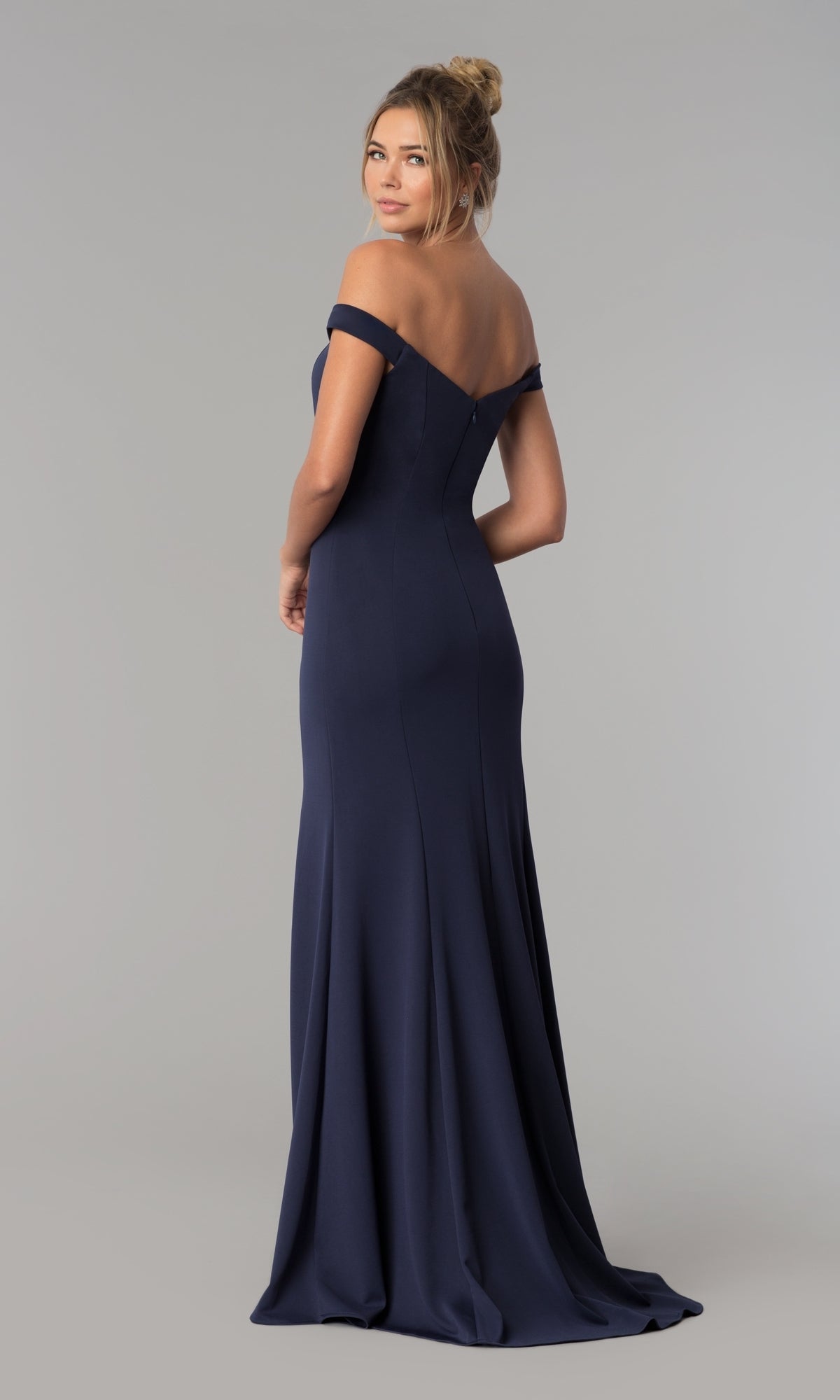 A woman, back turned and looking over her shoulder, models the Simple Off-the-Shoulder Long Formal Prom Dress 8160 in navy blue against a neutral background.
