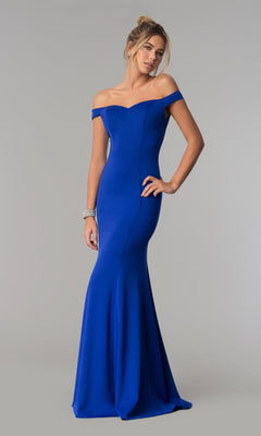 Woman modeling the Simple Off-the-Shoulder Long Formal Prom Dress 8160 in royal, featuring a fitted silhouette and flared hem, stands against a plain light gray background.