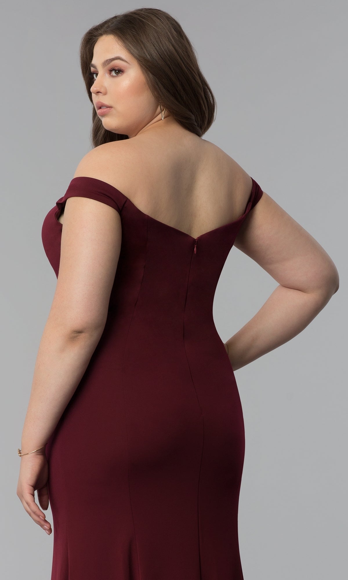 A woman models the Simple Off-the-Shoulder Long Formal Prom Dress 8160 in burgundy, standing with her back and side to the camera against a plain gray background.