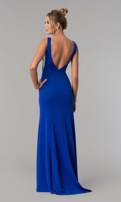 A woman faces away from the camera in the Sheer-Sided Backless Long Formal Prom Dress 8168, a sleeveless, floor-length royal blue gown with a deep V-back.