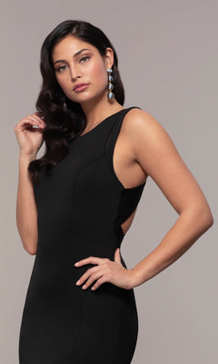 A woman with wavy dark hair and long dangling earrings poses elegantly in the Strappy-Open-Back Long Formal Prom Dress 8232 against a plain light background.