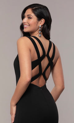 A woman stands smiling in the Strappy-Open-Back Long Formal Prom Dress 8232, styled with long earrings and her dark wavy hair cascading down her back.