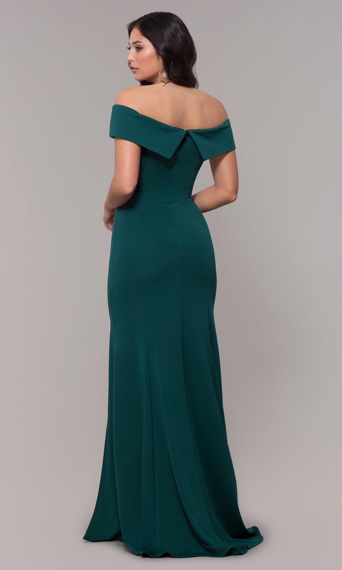 A woman models the Classic Off-the-Shoulder Formal Prom Dress 8258—a floor-length, fitted green jersey gown—facing slightly away to elegantly reveal its back against a simple backdrop.