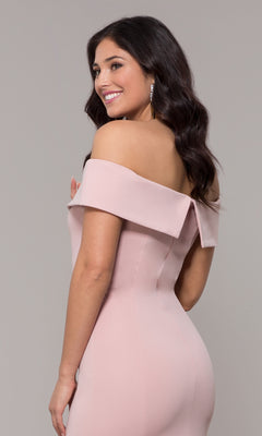 A woman with long dark hair smiles while posing against a plain background, wearing the Classic Off-the-Shoulder Formal Prom Dress 8258 in light pink.