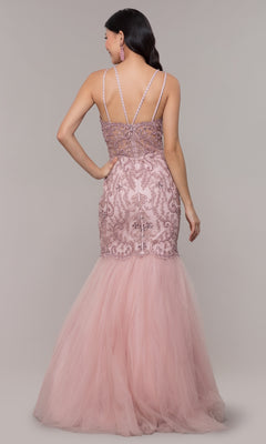 A woman is seen from the back wearing the Embroidered Tight Sweetheart Mermaid Prom Dress 8352 in blush pink, featuring lace and sequin details, double spaghetti straps, and a tulle mermaid skirt.