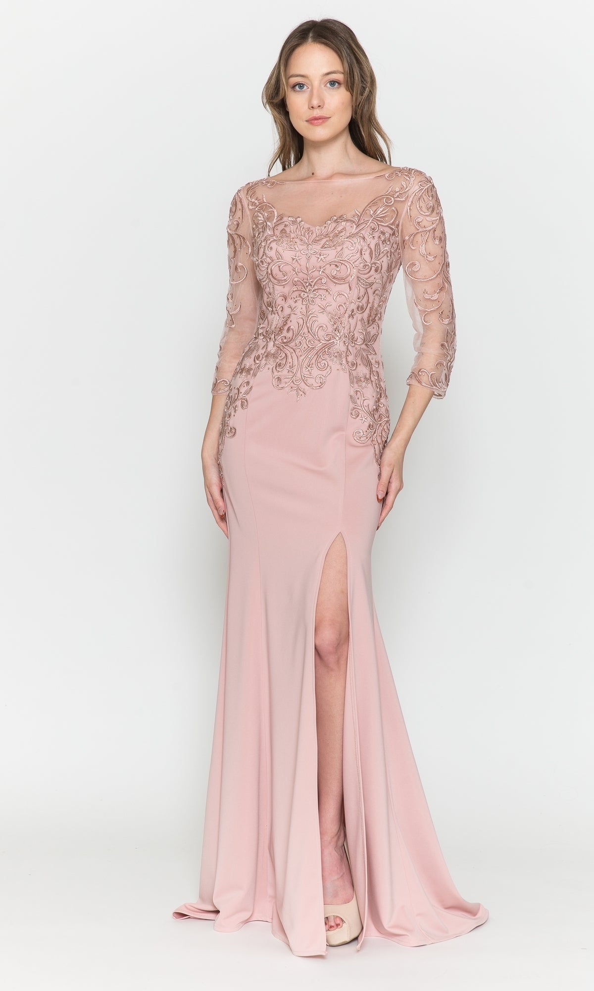 A woman wears the Embroidered Sheer-Sleeved Long Prom Dress 8564 in mauve, featuring a fitted bodice, sheer embroidered sleeves, and a high leg slit, standing against a plain white background.