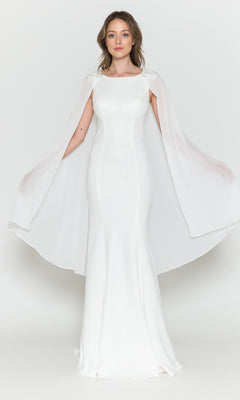 A woman models the High-Neck Simple Long Jersey Prom Dress 8566, featuring a floor-length silhouette and sheer cape sleeves, standing facing forward against a plain white background.