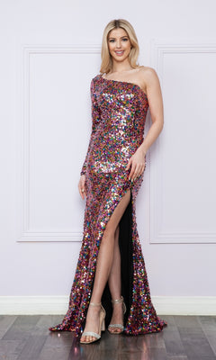 A woman in the One-Long-Sleeve Long Sequin Prom Dress 9022 in Black/Multi, a floor-length gown with a thigh-high slit, stands before a light-colored wall wearing metallic heels.