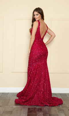 A woman poses with her back to the camera in the V-Neck Long Sequin Prom Dress 9108, a sparkly deep red, floor-length dress featuring a low back and fitted silhouette, set against a beige wall.