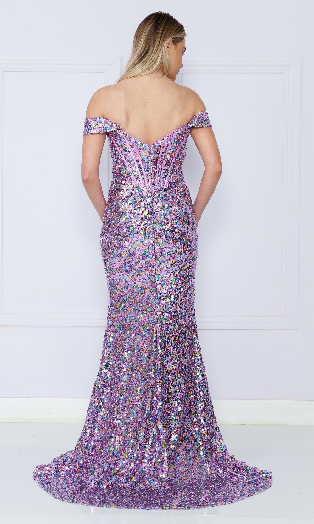A woman faces away, wearing the Off-Shoulder Long Sequin Corset Prom Dress 9150, a floor-length purple gown with an off-the-shoulder neckline, fitted corset bodice, and slight train.