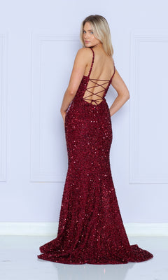 A woman models the Beaded-Fringe Long Sequin Prom Dress 9154, a sleeveless, floor-length burgundy gown with sequins and a lace-up back, standing and looking over her shoulder.