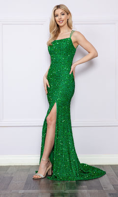 A woman poses in heeled sandals against a light-colored wall, wearing the Open-Back Long Sequin-Velvet Prom Dress 9158—an elegant green sleeveless gown with strappy back and thigh-high slit.