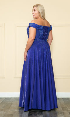 A woman stands indoors in the Plus-Size Long Beaded Prom Dress with Pockets W1112, a floor-length, off-the-shoulder gown with shimmer detail, facing slightly away from the camera.
