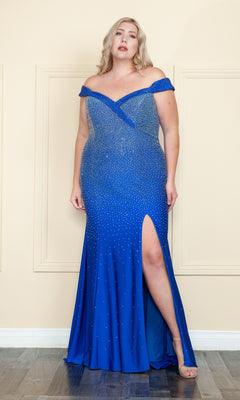 A woman in a beaded plus-size long corset prom dress (style W1120), featuring an off-the-shoulder neckline and thigh-high slit, stands indoors against a beige wall.