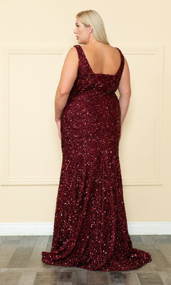 A woman with long blonde hair models the Velvet-Sequin Plus-Size Long Prom Dress W1122 in dark red, sleeveless and floor-length, shown from the back against a beige wall.