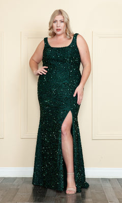 A woman wearing the Plus-Size Sleeveless Long Sequin Prom Dress W1126—dark green, sleeveless, floor-length with a thigh-high slit—stands against a cream wall on a wooden floor.