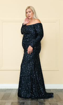 A woman models the Long Sleeve Plus-Size Long Sequin Prom Dress W8876 in navy, featuring shimmering sequins, while posing against a plain, light-colored wall on a wooden floor.