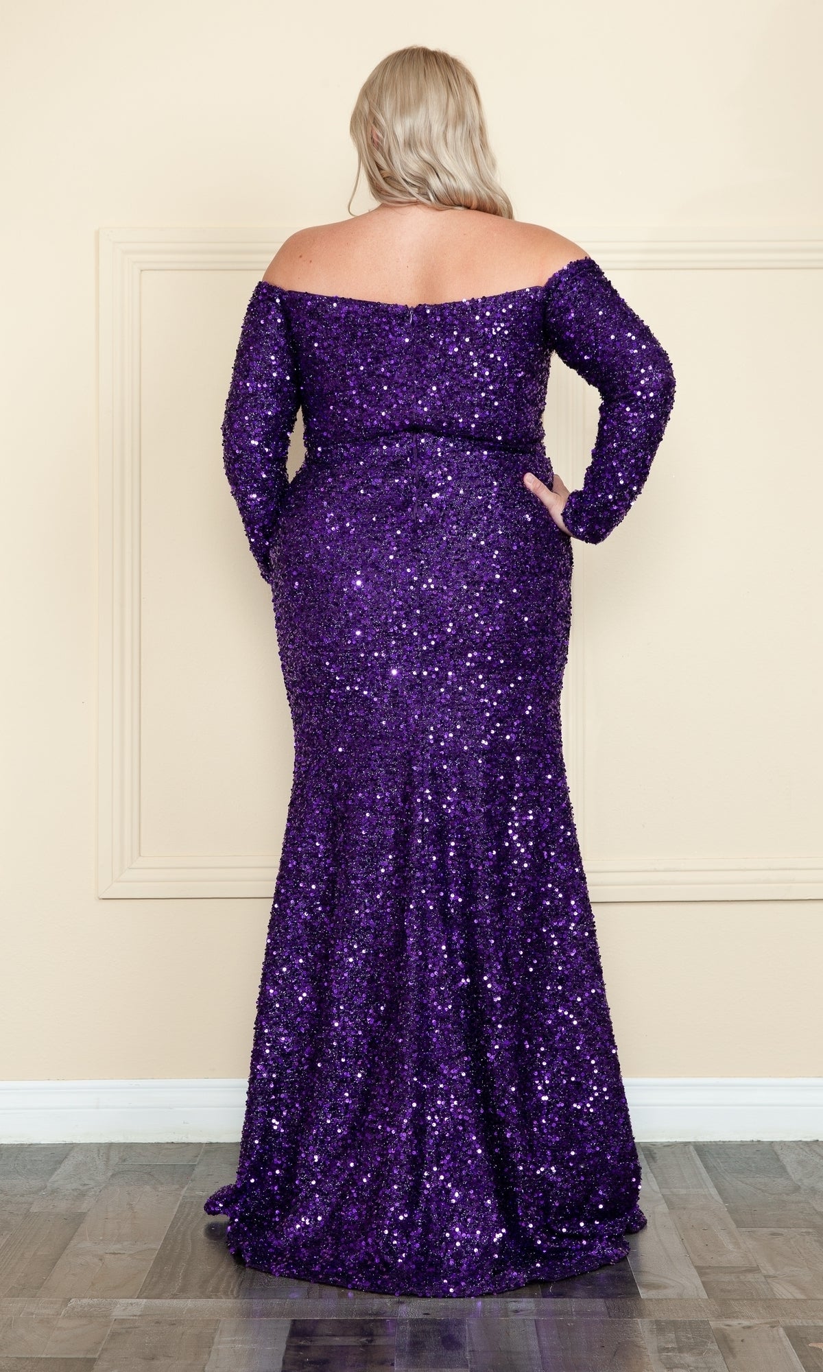 A person with long blonde hair faces away from the camera wearing the Long Sleeve Plus-Size Long Sequin Prom Dress W8876, a purple, floor-length gown.