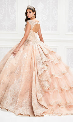 A young woman wearing the Princesa Traditional Lace Quinceañera Dress PR12002 and a tiara stands in an elegant room, facing backward and looking over her shoulder.