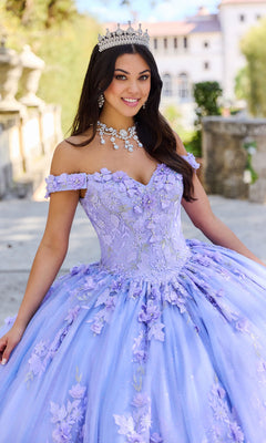 A woman stands outdoors, smiling at the camera in the Princesa Quinceañera Dress PR12263 with 3-D Flowers—a light purple, off-the-shoulder gown adorned with floral details and a tiara.