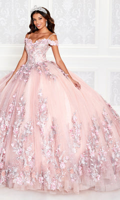 A woman wears the Princesa Quinceañera Dress PR12263 with 3-D flowers and a tiara, standing against a white ornate background.