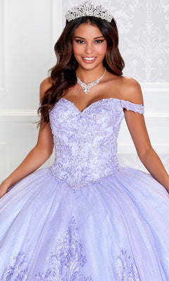 A woman in the PR12264 Princesa Quince Dress with glitter tulle, featuring intricate embroidery and an off-the-shoulder lavender design, poses wearing a tiara and necklace.