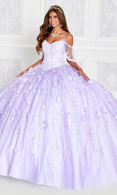 A young woman smiles indoors wearing the Cold-Shoulder Princesa Quinceanera Dress PR12271, a lilac ball gown with floral embellishments and off-the-shoulder sleeves.