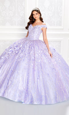 A woman in the Flower Quince Dress: Princesa by Ariana Vara PR22036, a lavender ball gown with floral details and a tiara, stands smiling slightly before an ornate white wall.