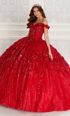 A woman wearing the Flower Quince Dress: Princesa by Ariana Vara PR22036, an off-the-shoulder red ball gown with floral and sequin details, and a jeweled tiara stands against a patterned white wall.