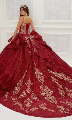 A woman in the PR22142 By Princesa Quinceanera Dress—red with gold embroidery and detachable sleeves—stands in a white room, facing away and looking over her shoulder.