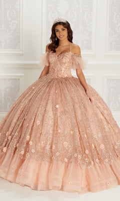 A young woman wears the Quinceanera Dress PR22144 by Princesa—a peach ball gown with off-the-shoulder sleeves, corset back, and sparkling floral details—paired with a jeweled tiara, standing against an ornate white background.