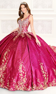 A woman in the Quinceanera Dress PR30081 By Princesa—sparkling magenta metallic jacquard with gold floral embroidery—wears matching earrings and a tiara as she stands in a decorated room.