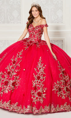 A woman in the Quinceanera Dress PR30114 By Princesa—bright red, off-the-shoulder with gold 3D floral appliques—wears a tiara and jeweled necklace as she stands in an ornate white room.