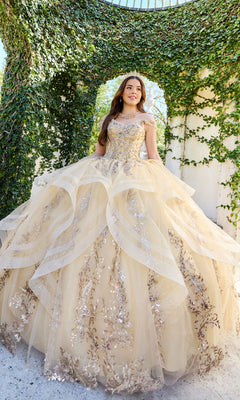 A young woman in the Quinceanera Dress PR30117 By Princesa with a detachable cape stands outdoors under an ivy-covered arch, looking to the side and smiling.