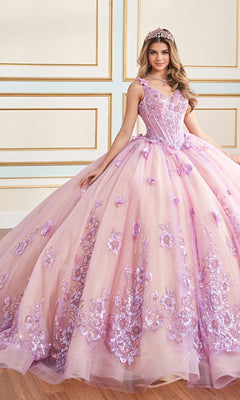 A young woman in the Quinceanera Dress PR30179 By Princesa, a pink and lavender glitter tulle gown with 3D flowers and a tiara, stands indoors against a white and gold wall.