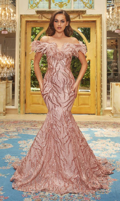 A woman stands indoors wearing the Long Prom Dress PS22227 by Portia and Scarlett in rose gold, an off-the-shoulder mermaid gown with feathered details, sparkling sequin print, fitted silhouette, and floor-length elegance.