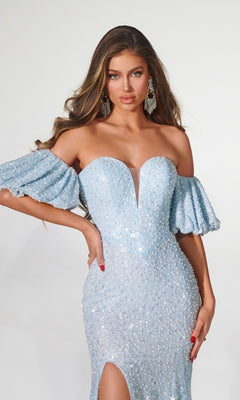 A woman wearing the Puff Sleeve Prom Dress: Portia & Scarlett PS23080, a fitted light blue sequin gown with off-the-shoulder details and thigh-high slit, stands against a plain background.