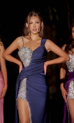 A young woman poses in the Portia and Scarlett PS23648E long navy prom dress, featuring an asymmetrical neckline, silver sequin embellishments, and a thigh-high slit.
