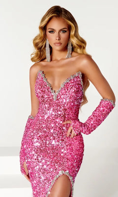 A woman models the Long Prom Dress PS23680 by Portia and Scarlett—a sparkling pink strapless sequin gown with silver trim—paired with matching long gloves and large dangling earrings against a plain background.