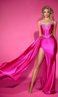 Model poses before a pink backdrop in the Portia and Scarlett PS25203 long formal dress, hot pink with crystal embellishments, high leg slit, and flowing train.