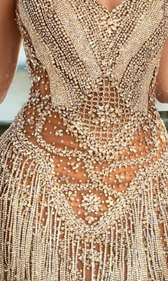 Close-up of the Portia and Scarlett PS25408C short homecoming dress, showcasing its strapless design with intricate beadwork and sparkling rhinestones in geometric and floral patterns over sheer nude fabric.