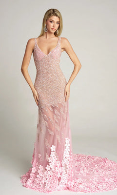 A woman wears the pink Portia and Scarlett Long Formal Dress (PS25987C), an embellished evening gown with sequin details, floral appliqués, and an illusion skirt. The sleeveless, floor-length dress contrasts with a plain light background.
