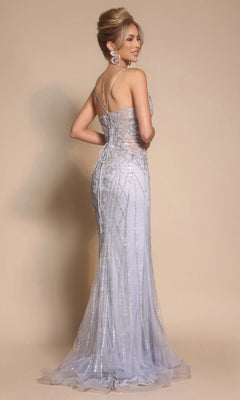 A woman in a light blue, floor-length Portia and Scarlett PS26033 formal dress with thin straps and sequin detailing stands facing away.