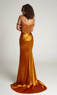 A woman in the Portia and Scarlett PS26046 long formal dress stands facing away, revealing an orange off-the-shoulder design with a fitted beaded corset bodice and a gathered flowing skirt that features a small train.
