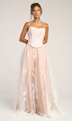 A woman stands against a plain background wearing the Portia and Scarlett PS26061 long formal dress in ivory/nude, featuring a strapless fitted bodice, A-line silhouette, and white lace floral overlay.