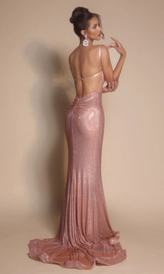 A woman poses in the Portia and Scarlett PS26068 long formal dress, a backless, floor-length, shimmering rose gold gown with a cowl neckline and her hair styled in an updo against a plain beige background.